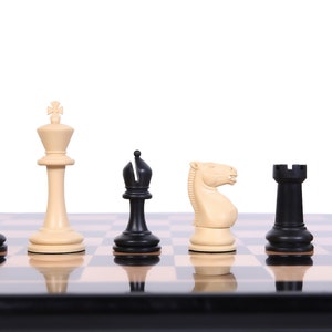 May include: A black and white chess set with pieces arranged on a wooden board. The pieces include a queen, king, knight, bishop, rook, and pawn.