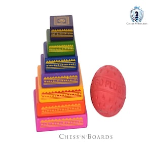May include: A colorful wooden stacking toy with seven blocks of different sizes and colors. The blocks are decorated with geometric patterns in yellow. The toy is stacked in a pyramid shape. A red rubber ball with the text "GO PLUS" is next to the toy.