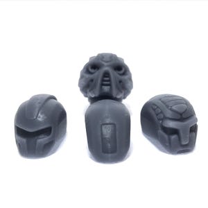 May include: Three grey plastic masks with different designs. The masks are for use with Lego minifigures.