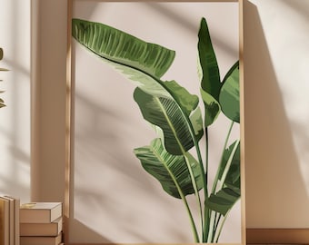 May include: A framed print of a tropical plant with large green leaves on a light pink background.