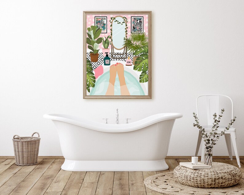 May include: A framed art print depicts a relaxing bathroom scene. The artwork shows a person's feet in a bathtub, surrounded by plants, a mirror, and decorative items. The color palette includes pink, green, and white, creating a calming atmosphere.