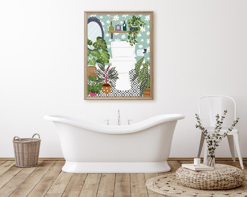 May include: A framed print of a bathroom with a toilet, plants, and a tiled floor. The print has a light blue background with white flowers and a wooden frame.