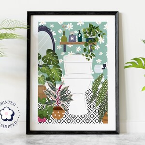 May include: A framed illustration of a bathroom with a white toilet, green and white floral wallpaper, and a variety of potted plants. The toilet is surrounded by plants, including a monstera plant, a fiddle leaf fig, and a prayer plant. The bathroom also features a small shelf with a mirror and a few decorative items.