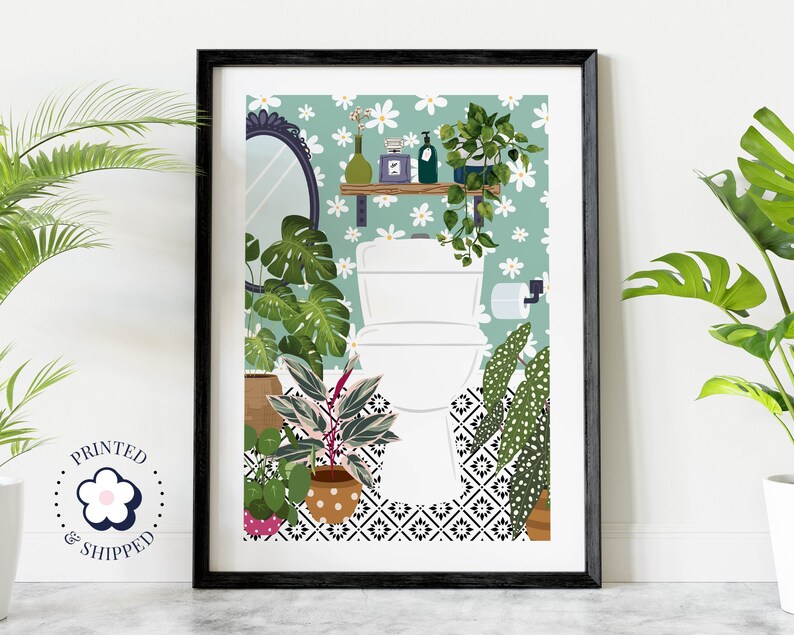 May include: A framed illustration of a bathroom with a white toilet, green and white floral wallpaper, and a variety of potted plants. The toilet is surrounded by plants, including a monstera plant, a fiddle leaf fig, and a prayer plant. The bathroom also features a small shelf with a mirror and a few decorative items.