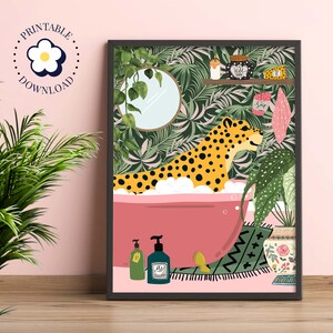 This colourful bathroom print features a leopard sitting in a pink bathtub surrounded by bottles and plants.  The background shows a tropical green wallpaper with scrubs and a candle on a shelf. A mirror with trailing ivy hang on the wall.