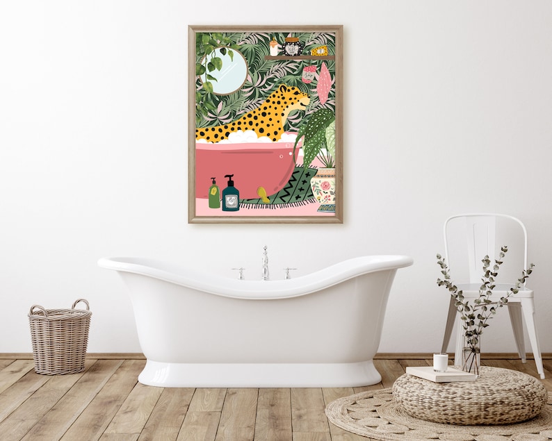 May include: A digital illustration of a leopard taking a bath in a pink bathtub surrounded by lush green plants. The illustration is framed in a light wood frame.