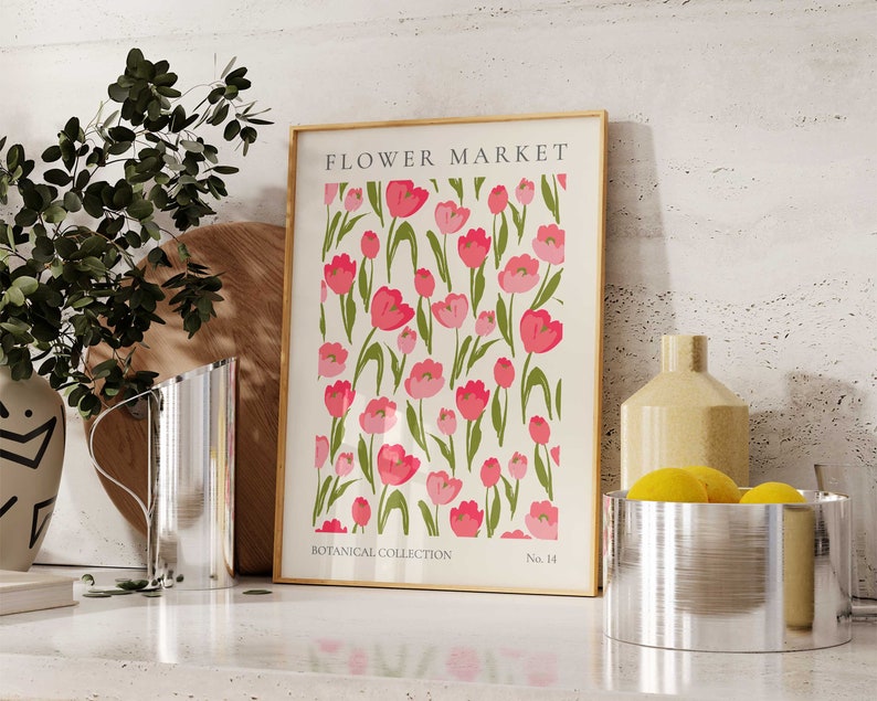 May include: A framed print featuring a white background with a repeating pattern of pink tulips with green stems and leaves. The print is titled "FLOWER MARKET" at the top, "BOTANICAL COLLECTION" at the bottom left, and "No. 14" at the bottom right.