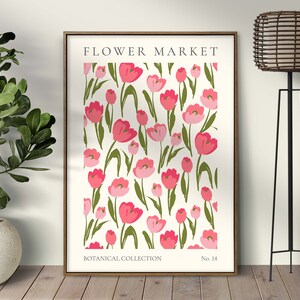 May include: A framed print featuring a white background with a repeating pattern of pink tulips and green leaves. The print is titled "FLOWER MARKET" at the top, with "BOTANICAL COLLECTION" at the bottom left and "No. 14" at the bottom right.