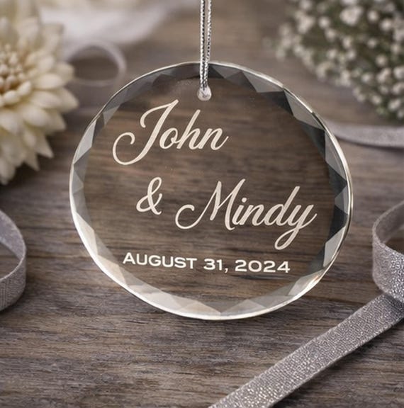 Round faceted crystal ornament personalized with a couple's names and anniversary date