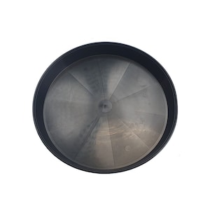 May include: A black plastic plant saucer with a ribbed design. The saucer is round and has a diameter of approximately 30 cm.