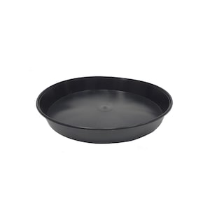 May include: A black plastic plant saucer, a round tray for catching excess water from potted plants.