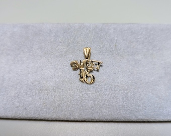 May include: Gold-toned pendant charm with the words "Sweet 16" in a stylized font.