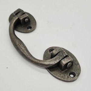 May include: A silver-toned metal drawer pull with a curved handle and two oval-shaped mounting plates.