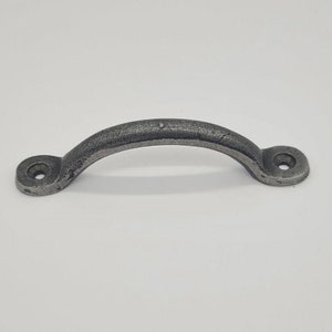 May include: A silver-toned metal drawer pull with a rounded, arched shape. The pull has two small holes on either end for mounting.
