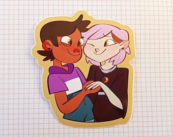 May include: A sticker featuring two cartoon characters, one with brown hair and a purple and white shirt, and the other with pink hair and a black shirt. They are holding hands and smiling at each other.