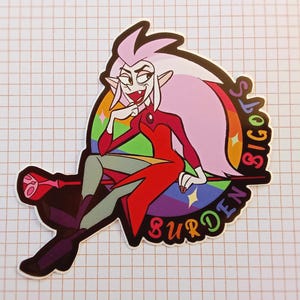May include: A pink-haired cartoon character with red and green clothing sits on a rainbow-colored throne. The throne has the words "Burden" and "Bigots" on it.