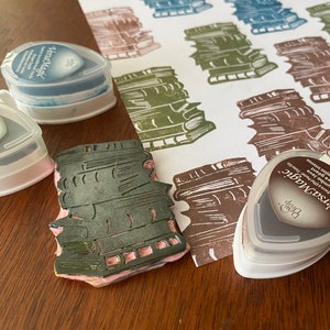Stack of books with ink pads used for repeating pattern.