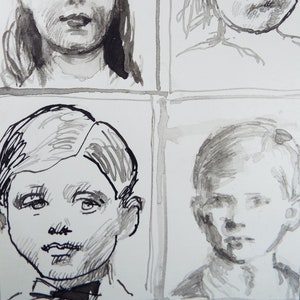 May include: A black and white ink drawing of four faces. The faces are drawn in a simple style with minimal detail. The drawing is on a white background.