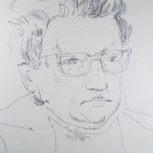May include: A black and white pencil drawing of a person wearing glasses. The person has short, messy hair and is looking directly at the viewer.