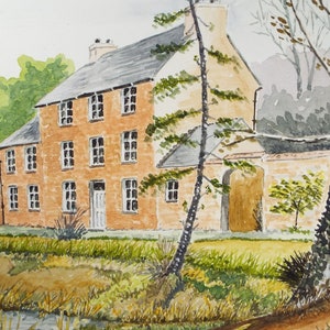 May include: Watercolour painting of a brick house with a grey roof and a tall tree in front. The house has many windows and a door. The tree is in the foreground and the house is in the background. There is a small stream in the foreground.