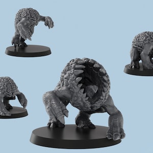 May include: A gray, detailed miniature of a creature with a large, open mouth and a textured, brain-like body. The creature has four legs and is standing on a black base.