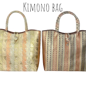 May include: Two brown and gold striped tote bags with leather handles and a decorative buckle. The bags are made of a fabric with a woven pattern. The text "KIMONO BAG" is written in black at the top of the image.