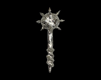 May include: A silver mace with a spiked head and a spiraled handle. The medieval weapon is set against a black background, highlighting its metallic sheen and intricate design. The mace is a symbol of power and authority.