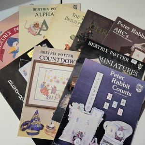 May include: A collection of Beatrix Potter themed craft booklets featuring titles such as Peter Rabbit ABC's, Peter Rabbit Counts, Beatrix Potter Miniatures, and Beatrix Potter Countdown. The covers display various illustrations of characters and embroidery projects.