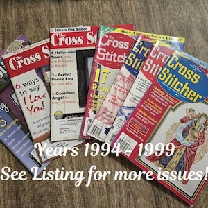May include: A collection of vintage "Cross Stitch" magazines from 1994-1999, featuring colorful covers with cross-stitch patterns and holiday themes. The text "See Listing for more issues!" is visible.