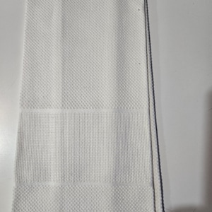 May include: A folded white kitchen towel with a textured diamond pattern. The towel has a rectangular shape with a horizontal band of a different texture. The towel is made of a soft, absorbent material.