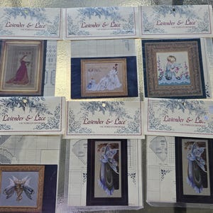 May include: Several cross-stitch kits from "Lavender & Lace" Victorian Designs. The kits feature framed images of women, angels, and fairies. The kits are packaged with the brand name and logo at the top.