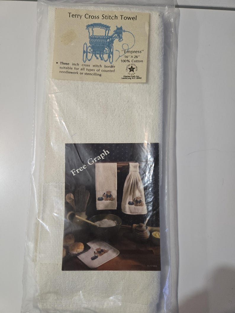 May include: A packaged terry cross stitch towel. The label reads "Terry Cross Stitch Towel" and "Empress" 16" x 26" 100% Cotton. The package also includes a "Free Graph" image of a cross-stitched towel set.