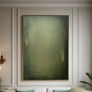 May include: A white sectional sofa with green velvet throw pillows in a living room with a large abstract painting in muted green tones, a coffee table with a vase of flowers, and a potted plant.