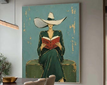 May include: A large rectangular canvas painting featuring a figure in a dark green dress and a wide-brimmed white hat, sitting and reading a red book. The background is a teal blue color with gold leaf accents throughout the composition.