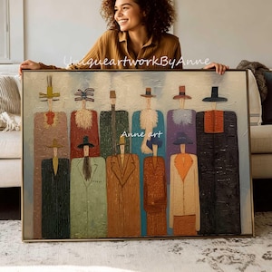 May include: A rectangular framed painting featuring eleven stylized figures wearing long coats and hats in various colors including brown, green, blue, purple, and black. The artwork includes the text UniqueartworkByAnne and Anne art.