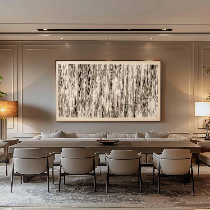 May include: A modern dining room featuring a long wooden table with six beige chairs. Above the table hangs a large framed abstract artwork with vertical lines. The room has neutral tones and a rug.
