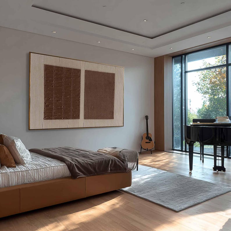 Puede incluir: Un dormitorio moderno con una gran obra de arte abstracta con texturas marrones y crema. La habitaci&oacute;n incluye una cama con base de cuero marr&oacute;n, un piano de cola y una guitarra. Una gran ventana ofrece vistas al exterior.