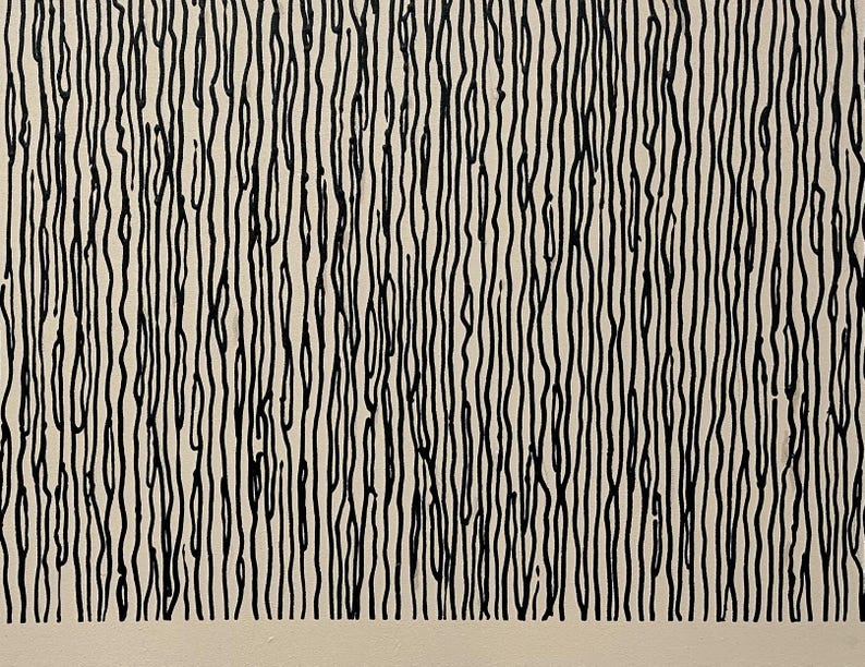 May include: Abstract artwork featuring a pattern of vertical black lines on a cream-colored background. The lines vary in thickness and have a slightly organic, hand-drawn quality, creating a textured visual effect. The artwork has a minimalist aesthetic.