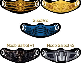 May include: Four different face masks featuring characters from the Mortal Kombat video game series. The masks are black with a white outline and feature the characters Scorpion, Sub-Zero, and Noob Saibot. The masks are labeled with the character's name and version number.