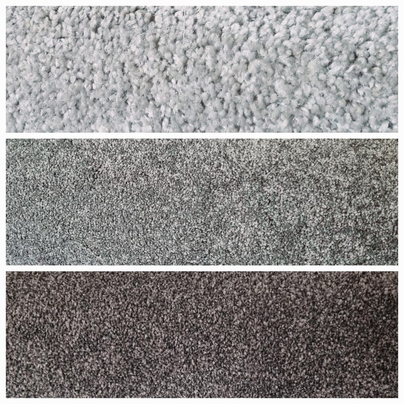 Puede incluir: Primer plano de tres muestras de alfombras en diferentes tonos de gris. La muestra superior es de un gris claro, la del medio es de un gris medio y la inferior es de un gris carb&oacute;n oscuro. La textura de cada muestra es densa y afelpada.