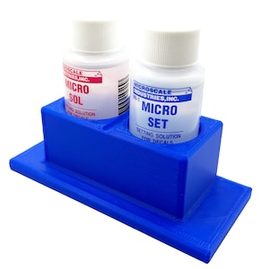 May include: A blue 3D-printed holder with two bottles of Microscale Industries setting solutions. One bottle is labeled "MICRO SOL" and the other "MICRO SET". The holder is designed to keep the bottles upright.