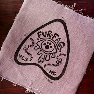 May include: A set of three ceramic mugs with a speckled, cream-colored glaze. Each mug features a different hand-painted floral design in shades of blue, green, and yellow. The mugs have a simple, rounded shape and a comfortable handle.