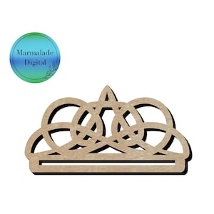 May include: A brown wooden crown with a detailed design. The crown is made of multiple interlocking circles and has a flat base.