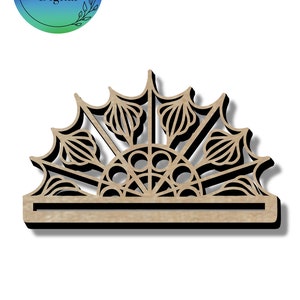 May include: A laser cut wooden sunburst design with intricate details. The design features a circular center with radiating lines and a decorative border.