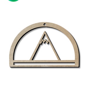May include: Wooden cutout of a mountain with a half circle frame and a small hole at the top for hanging. The cutout is a light brown color.