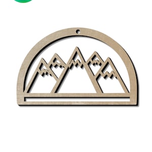 May include: A wooden cutout of a mountain range with a half-circle frame and a hole at the top for hanging. The mountains are stylized with jagged peaks and a flat base.