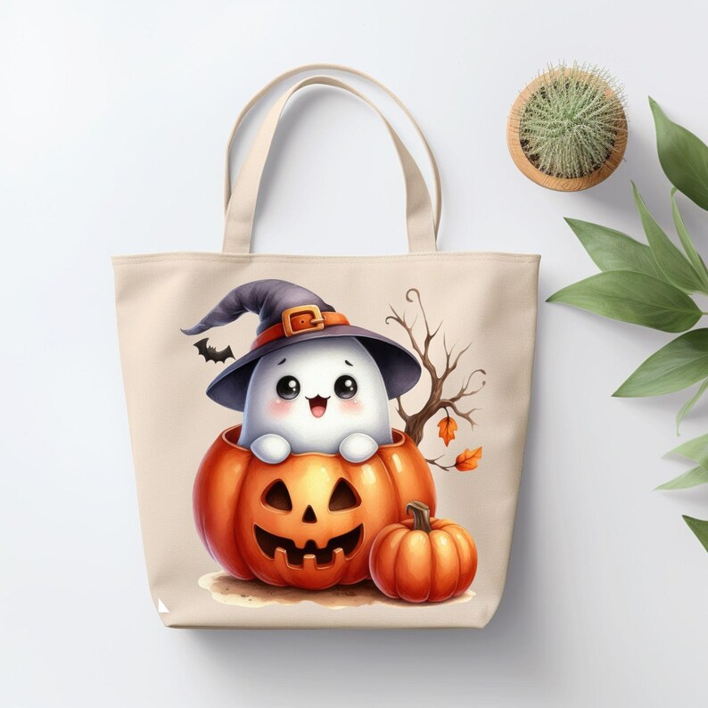 May include: A beige tote bag with a cute ghost wearing a witch hat and sitting inside a jack-o'-lantern. There is a smaller orange pumpkin next to the jack-o'-lantern.
