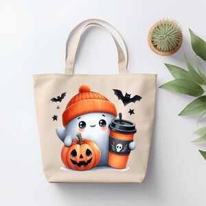 May include: A beige tote bag with a cute cartoon ghost wearing an orange and white hat, holding a pumpkin and a cup of coffee. The ghost has big eyes and a friendly smile. There are bats and stars in the background.