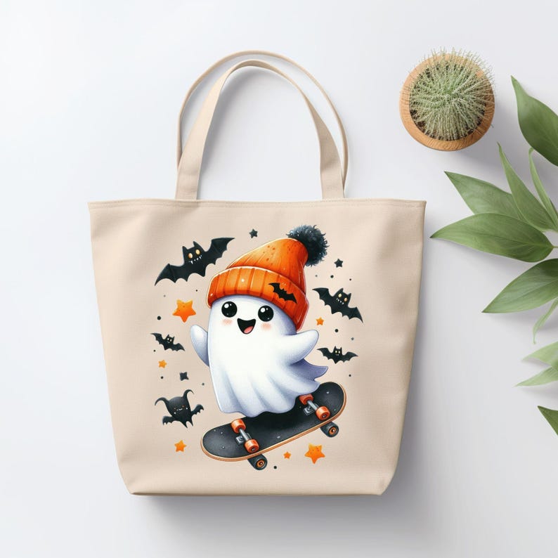 May include: A beige tote bag with a cute cartoon ghost wearing an orange and black beanie and riding a skateboard. The ghost is surrounded by black bats and orange stars.