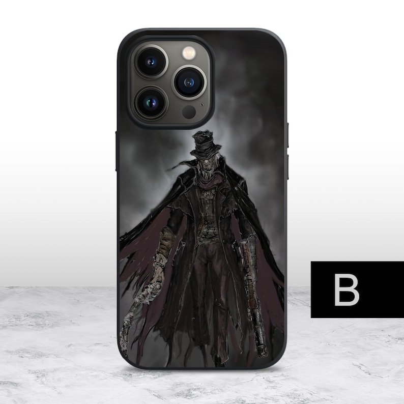 May include: Black phone case with a graphic of a man in a black coat and hat, holding a gun and a knife. The background is a dark, foggy scene.
